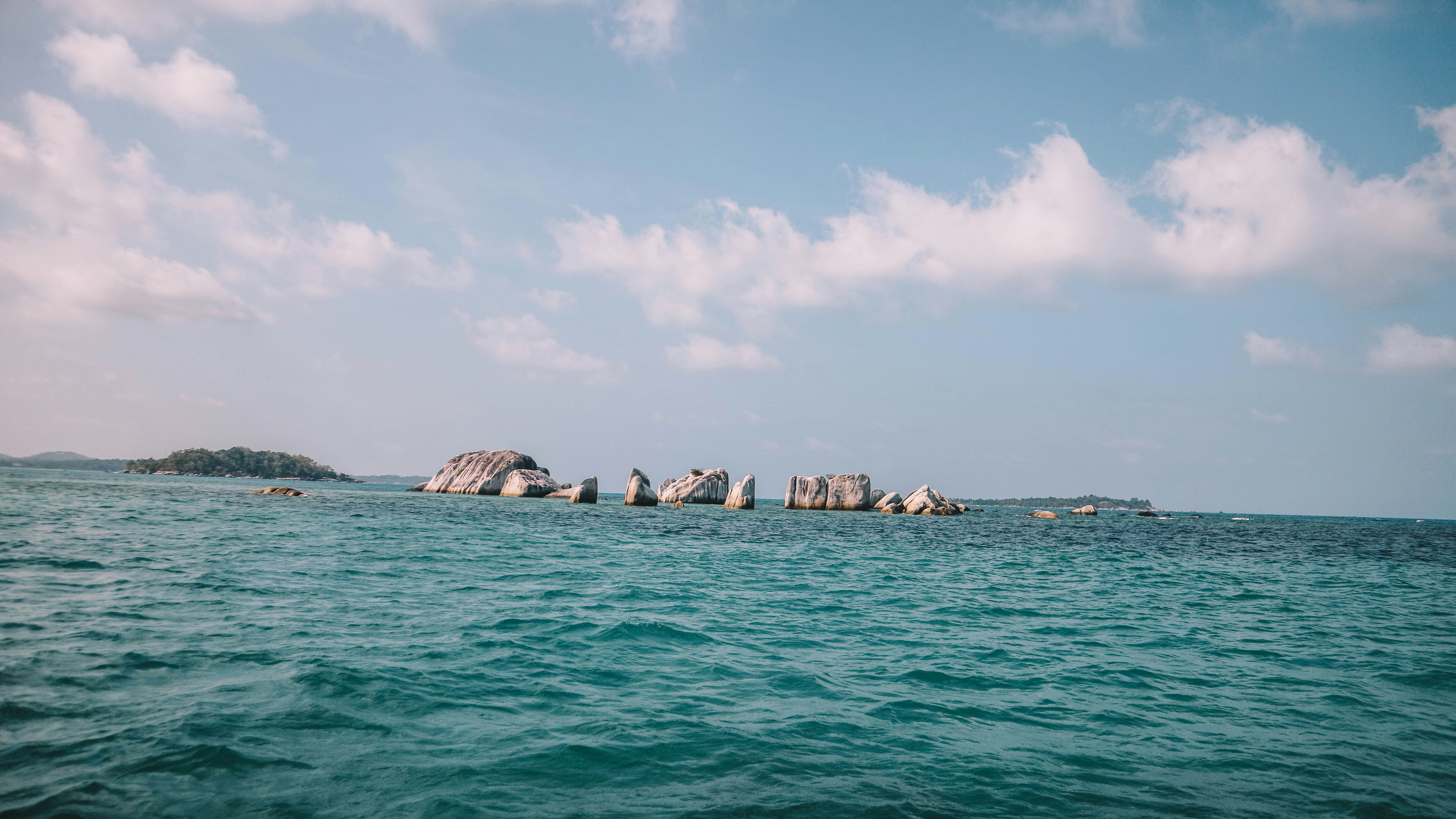 a group of rocks sticking out of the ocean