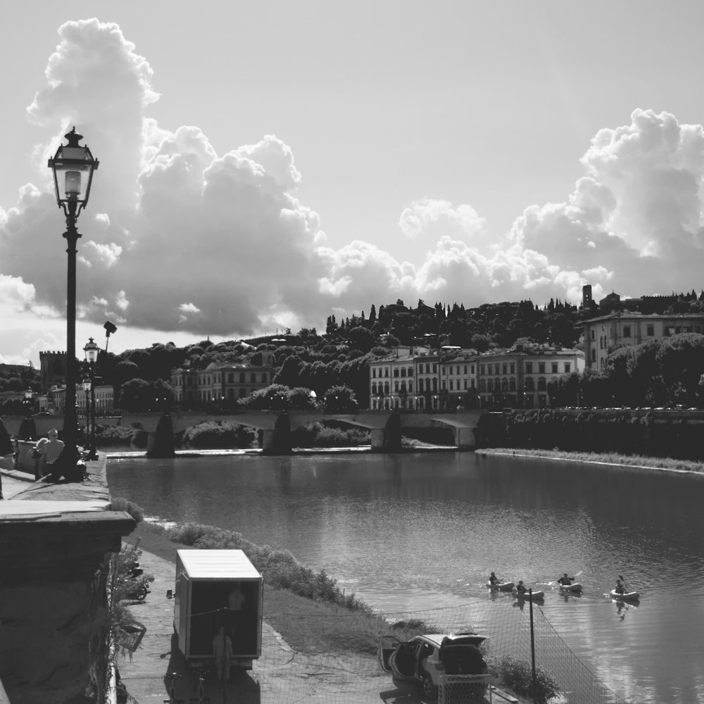 greyscale photo of buildings and boats