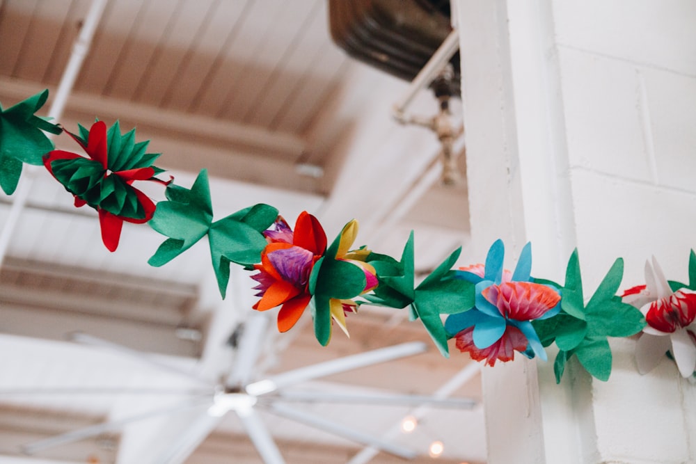 red and green paper flowers on wall