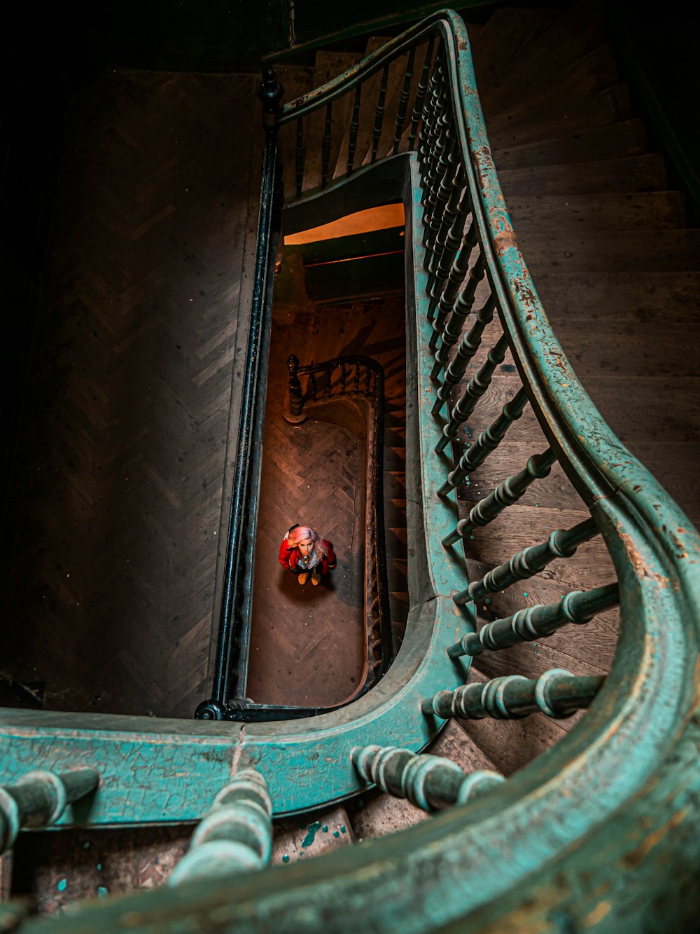 a red ball sitting on top of a metal stair case