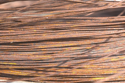 A close-up photo of shiny copper wires bundled together in a scrapyard.