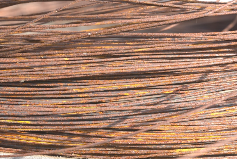 Close-up of rusted copper wires bundled together, ready for recycling.