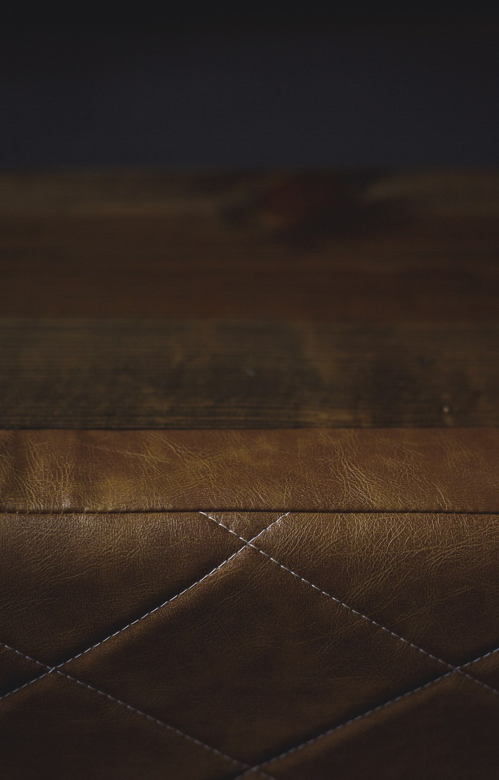 a close up of a brown leather bench