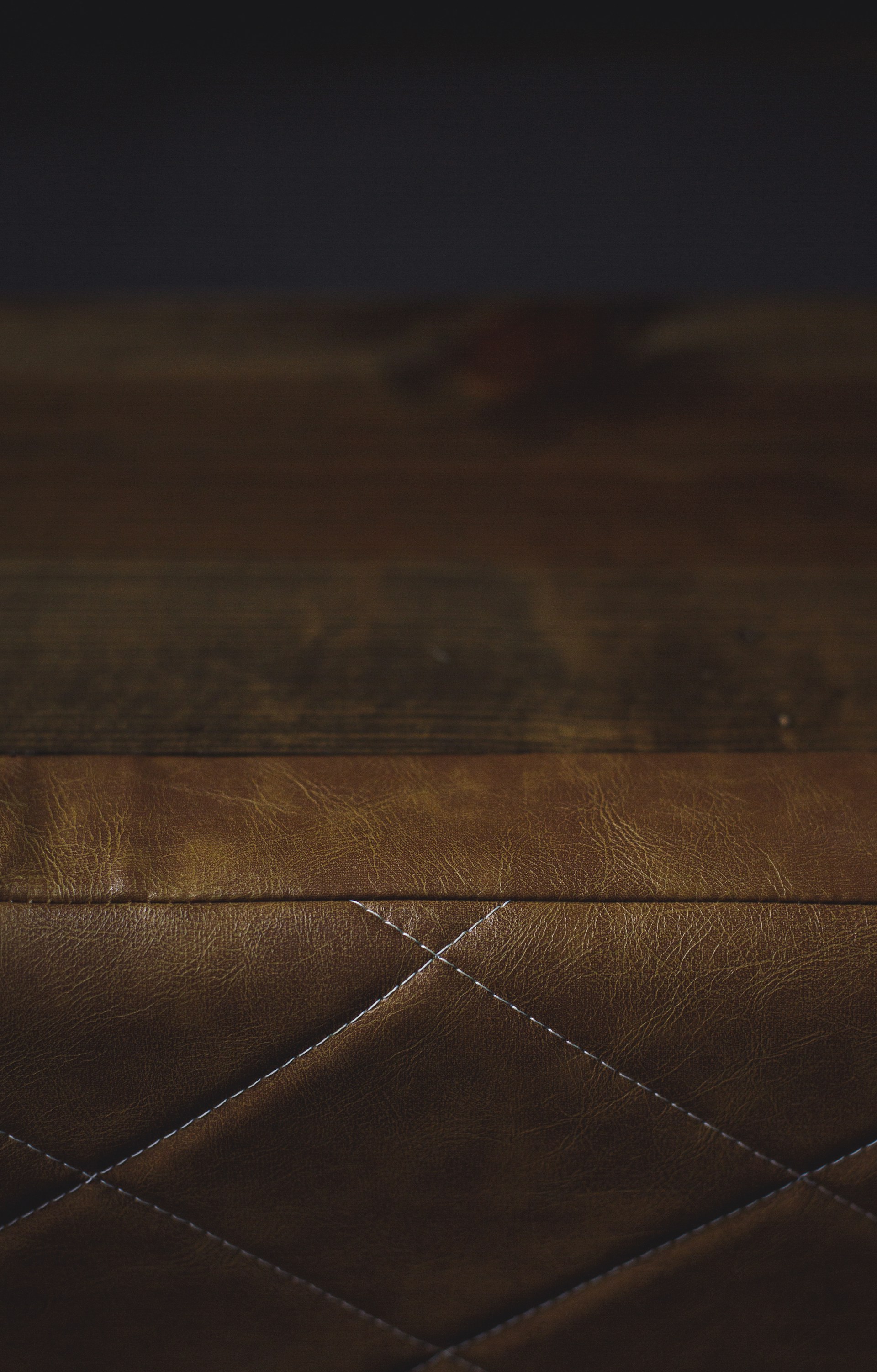 a close up of a brown leather bench
