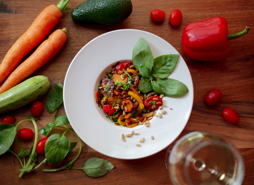 plate of food surrounded by uncut vegetables