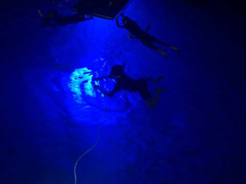 Underwater grout injection being performed by specialized divers
