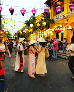 A lively street market in Vietnam filled with colorful lanterns and smiling locals