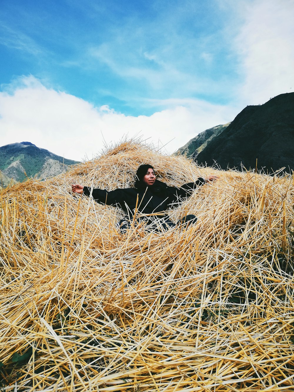 woman lying on a mountain of hay