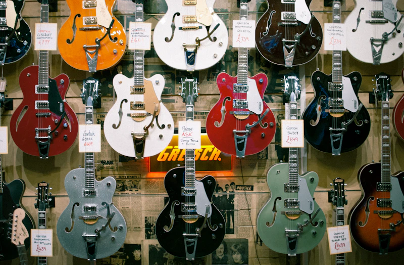 Collection of acoustic and electric guitars on display