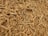 A large pile of dried roots with a rough, fibrous texture. The roots are twisted and intertwined, varying in thickness and length. They have a light brown color and appear natural and unprocessed.