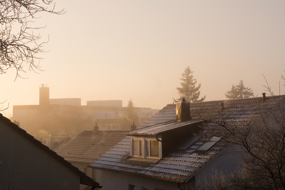 a view of rooftops with a foggy sky in the background