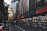 A bustling street with people engaging with digital displays.