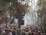 A panoramic view of a forest clearing transformed into a lively dance floor