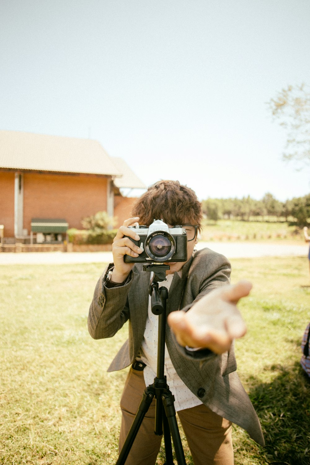 man holding camera on tripod