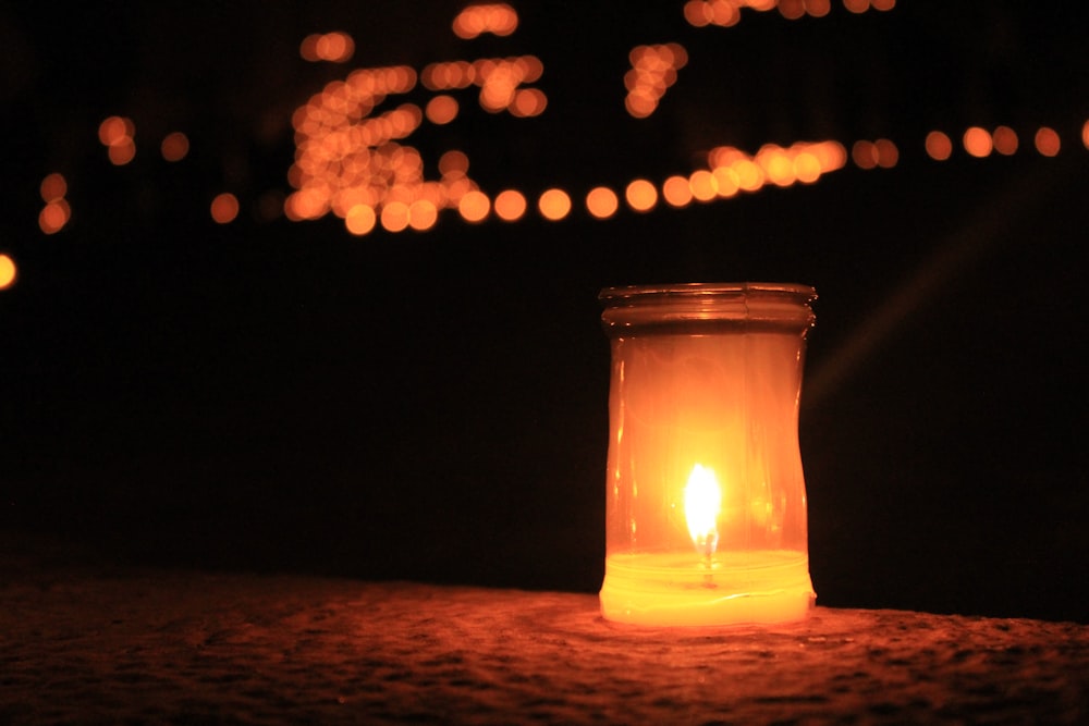 a lit candle sitting on top of a table