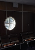 Waiting area with comfortable chairs and warm natural light from large windows.