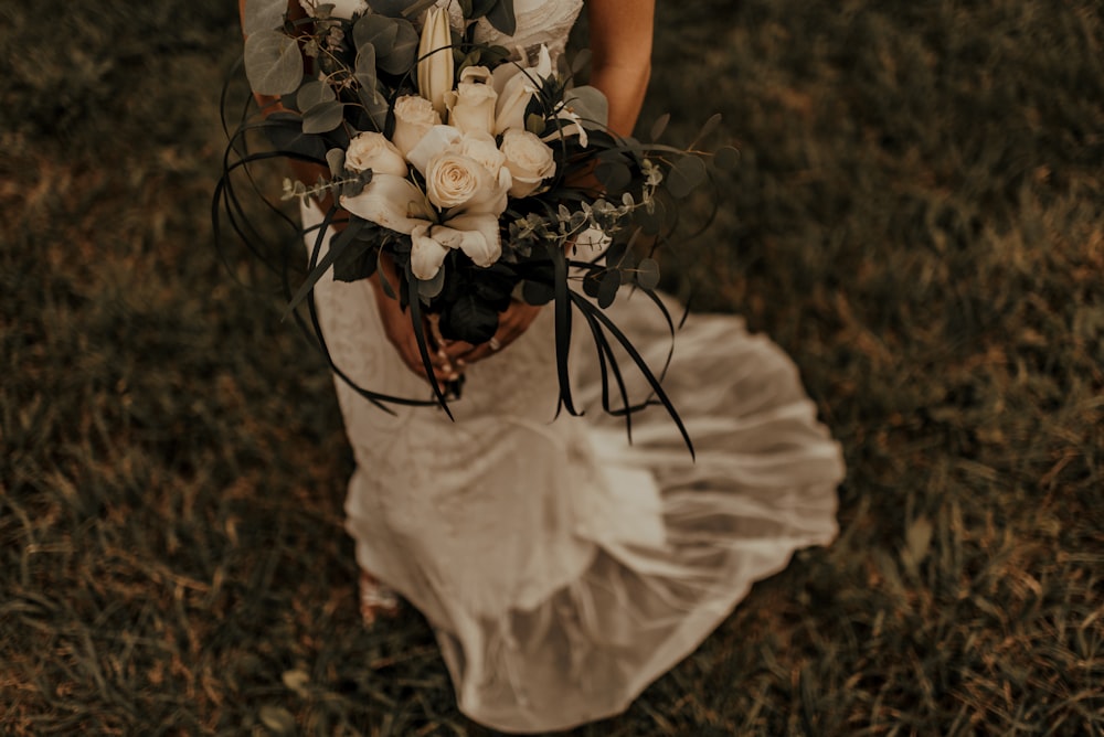 woman holding white flowers