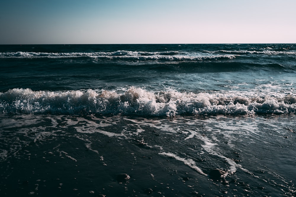 a body of water with waves coming in to shore