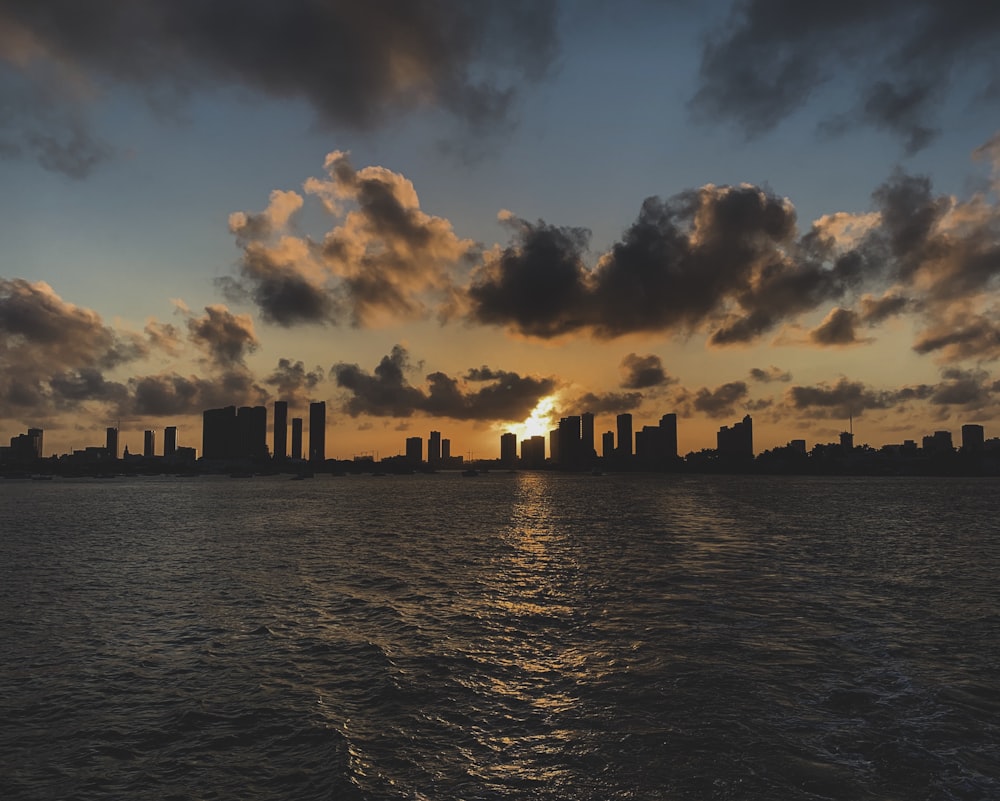 silhouette of city skyline under cloudy sky