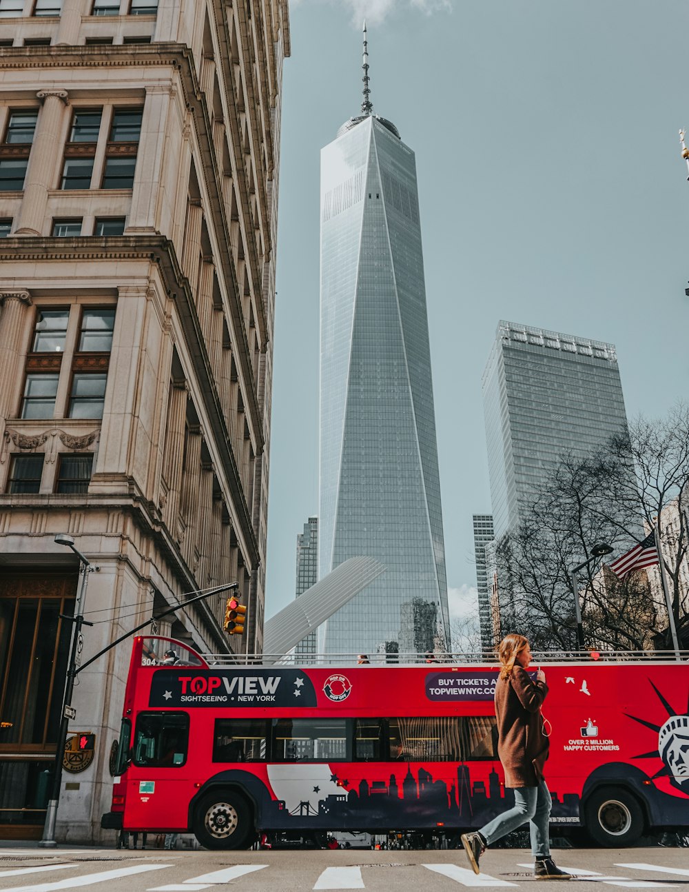 red bus near brown concrete building during daytime