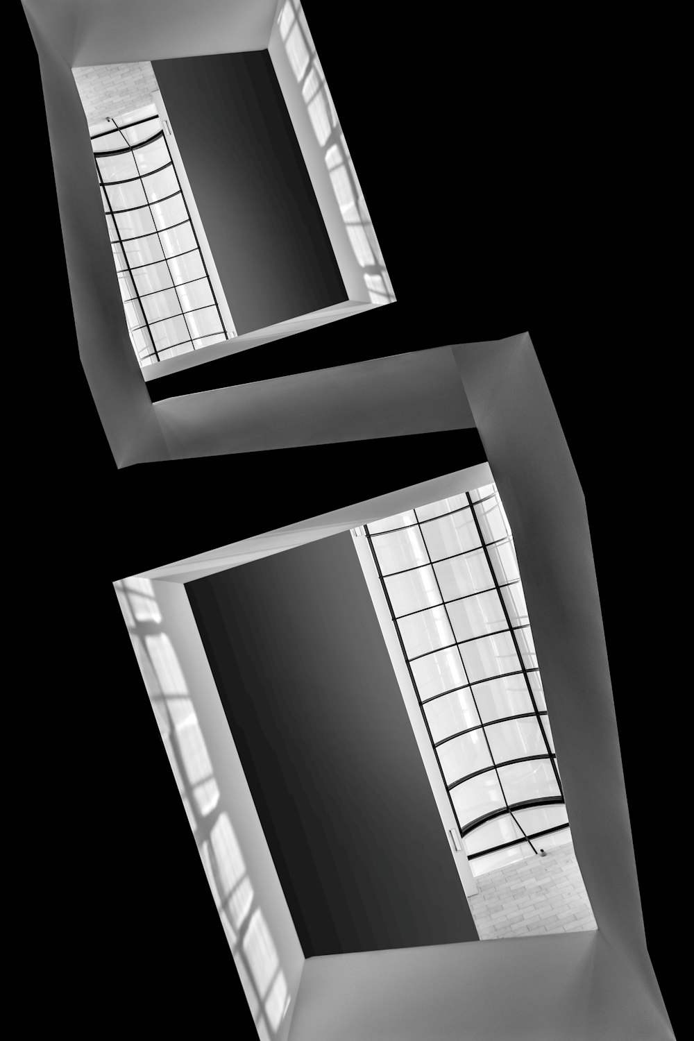 a black and white photo of two windows