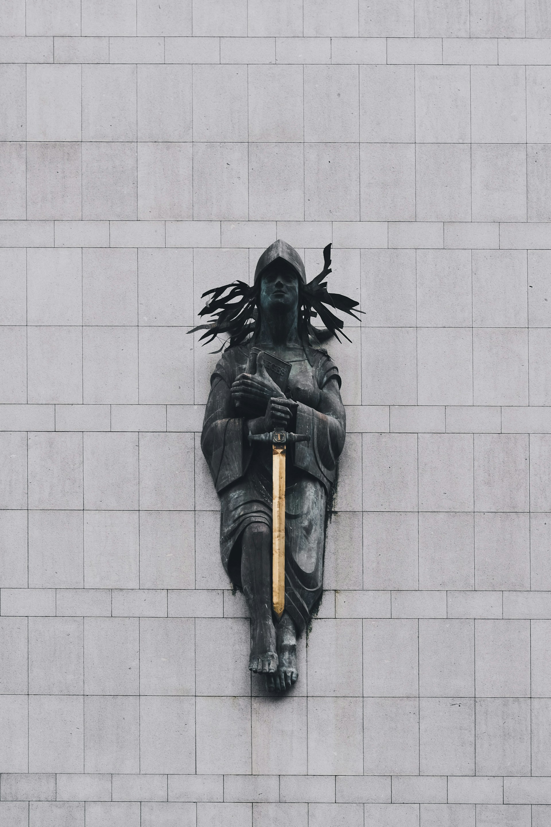 person with sword statue