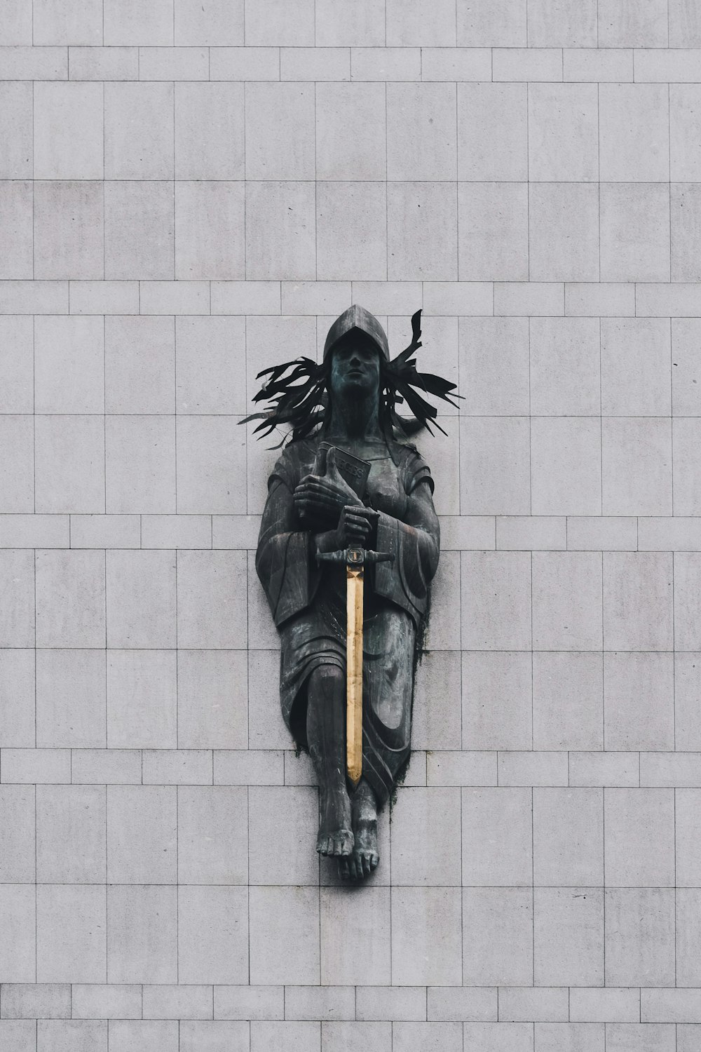 person with sword statue