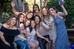 group of women taking picture during daytime