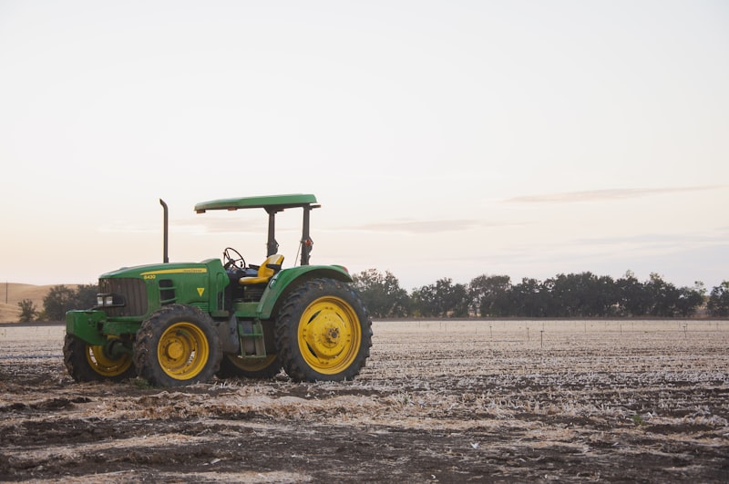 Green tractor near barn