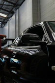 Close-up of a glossy black epoxy floor reflecting ambient lighting in a modern garage.