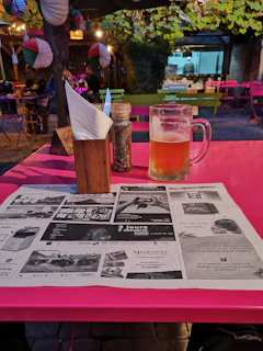 A vibrant outdoor picnic with friends sharing caféaura coffee in stylish mugs.