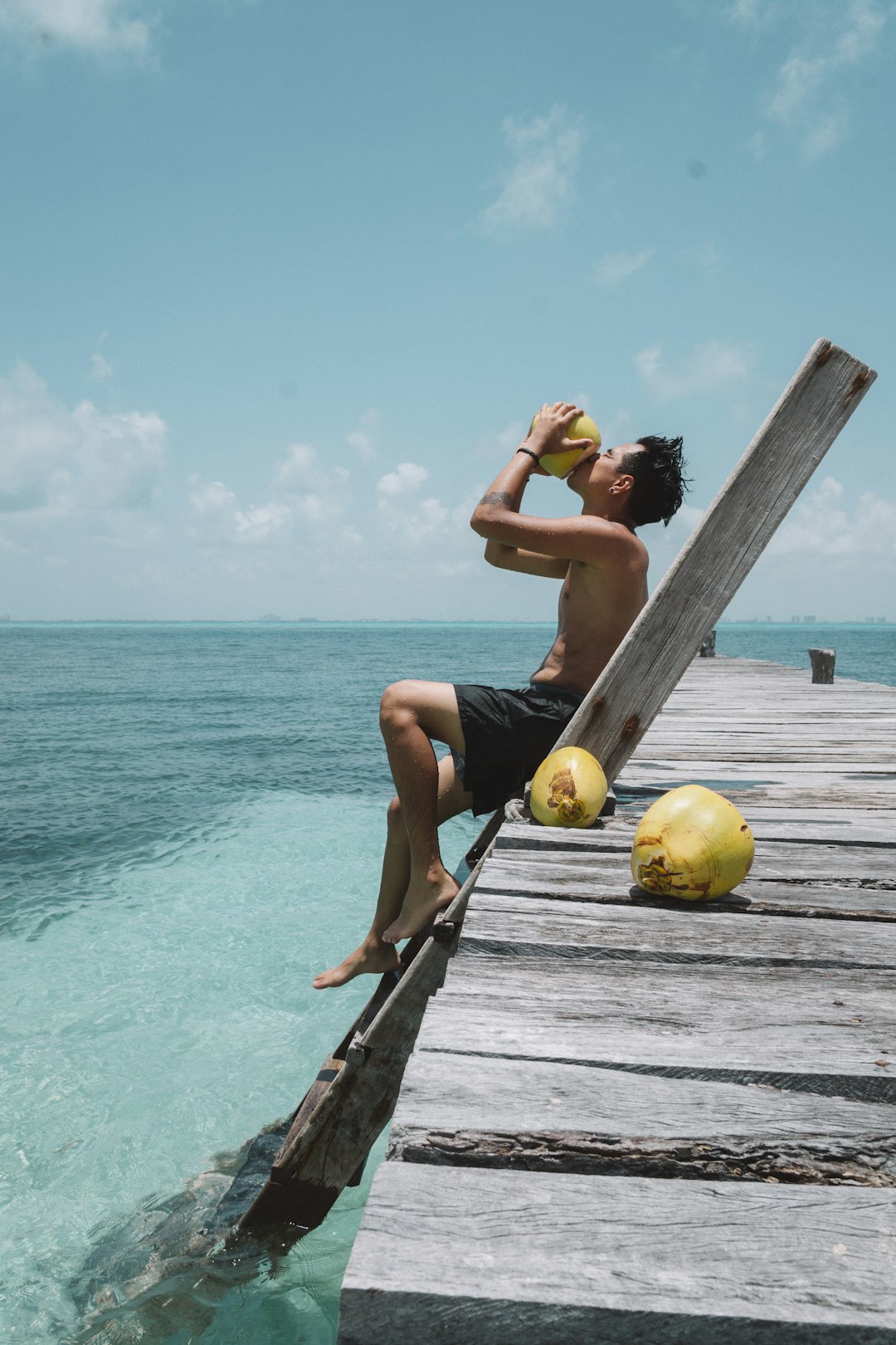 person drinking coconut fruit