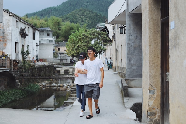 A happy elderly couple enjoying a peaceful walk along a quiet Romanian village street.