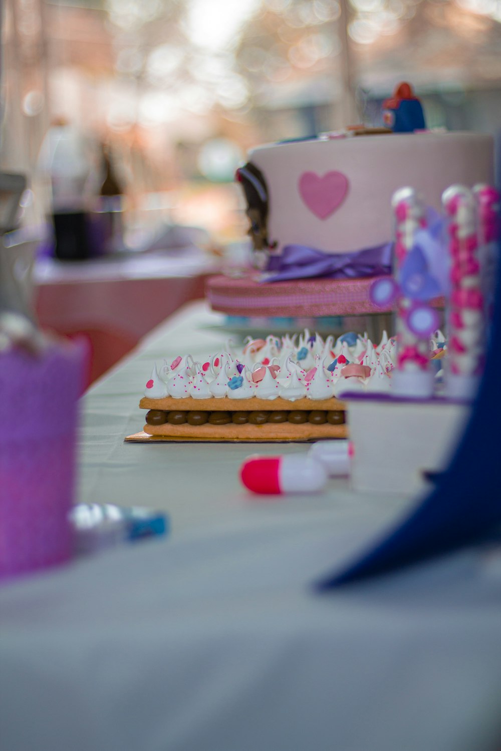 selective focus photography of cake and desserts on white table