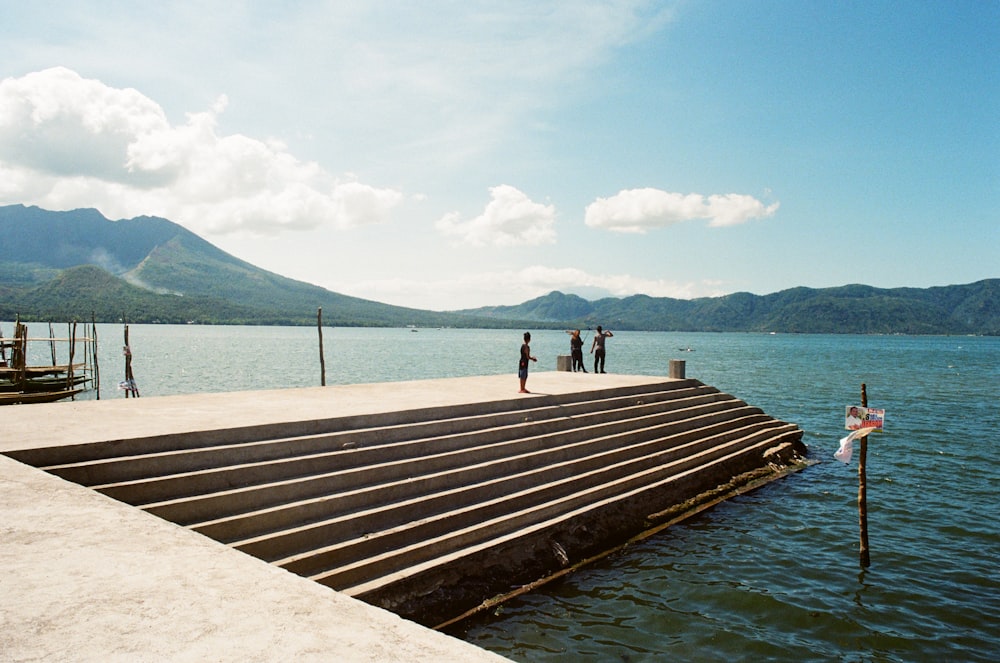 people on concrete dock during daytime