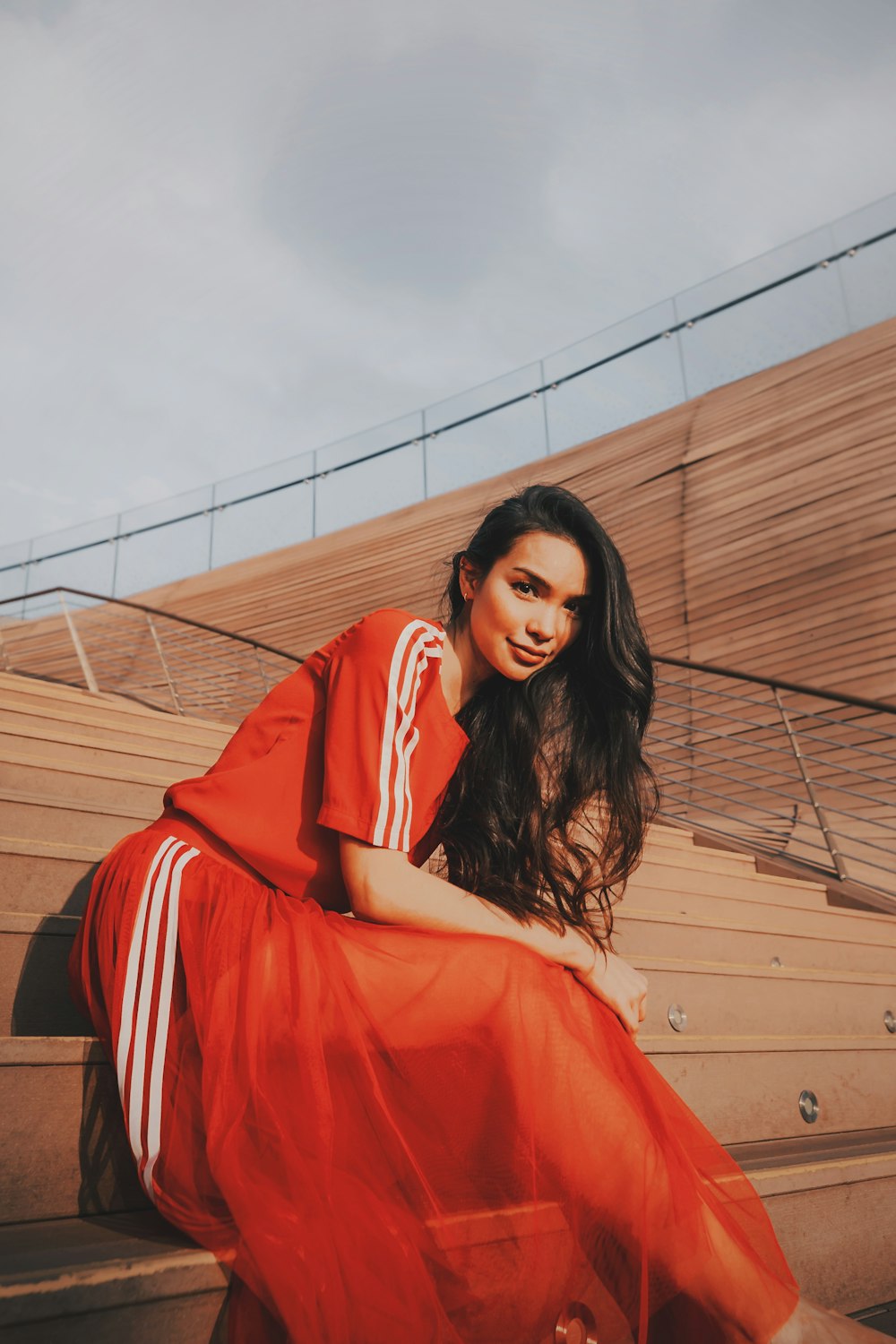 woman wearing red and white striped shirt and skirt sitting