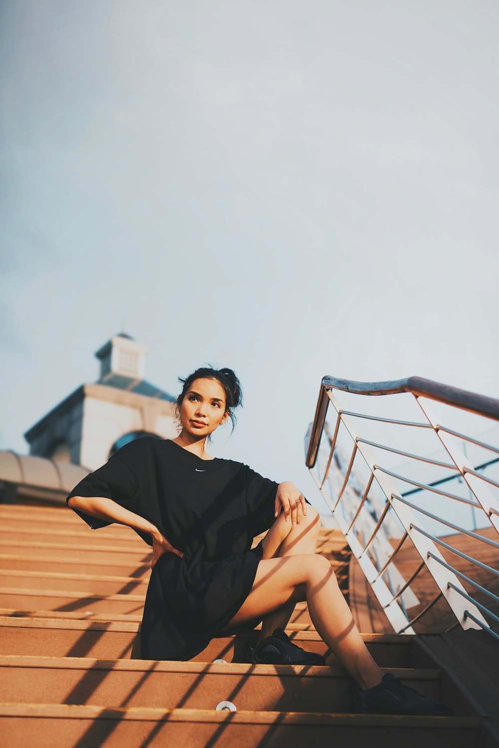 woman sitting on stair during daytime