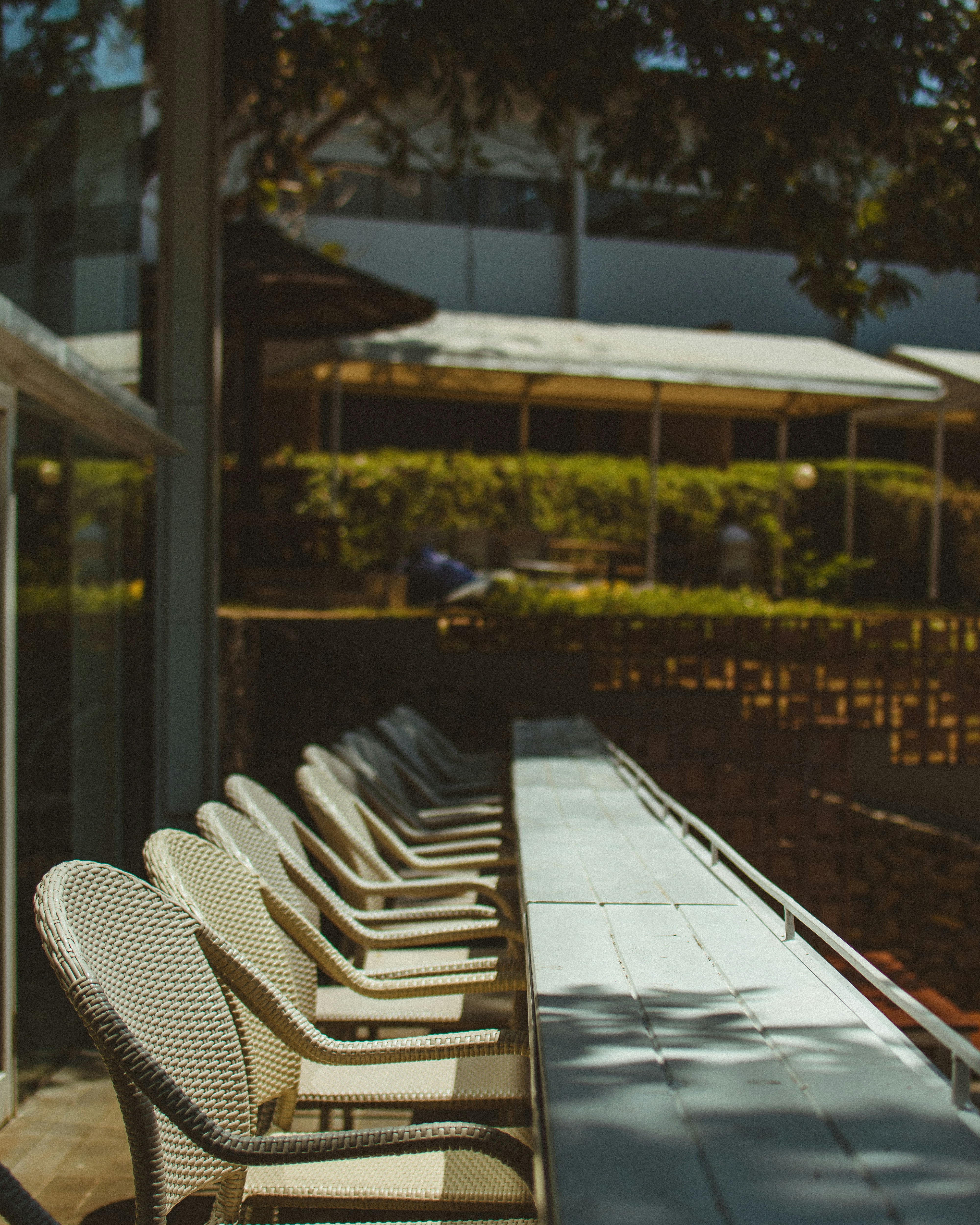 empty white chairs lot outside buildings
