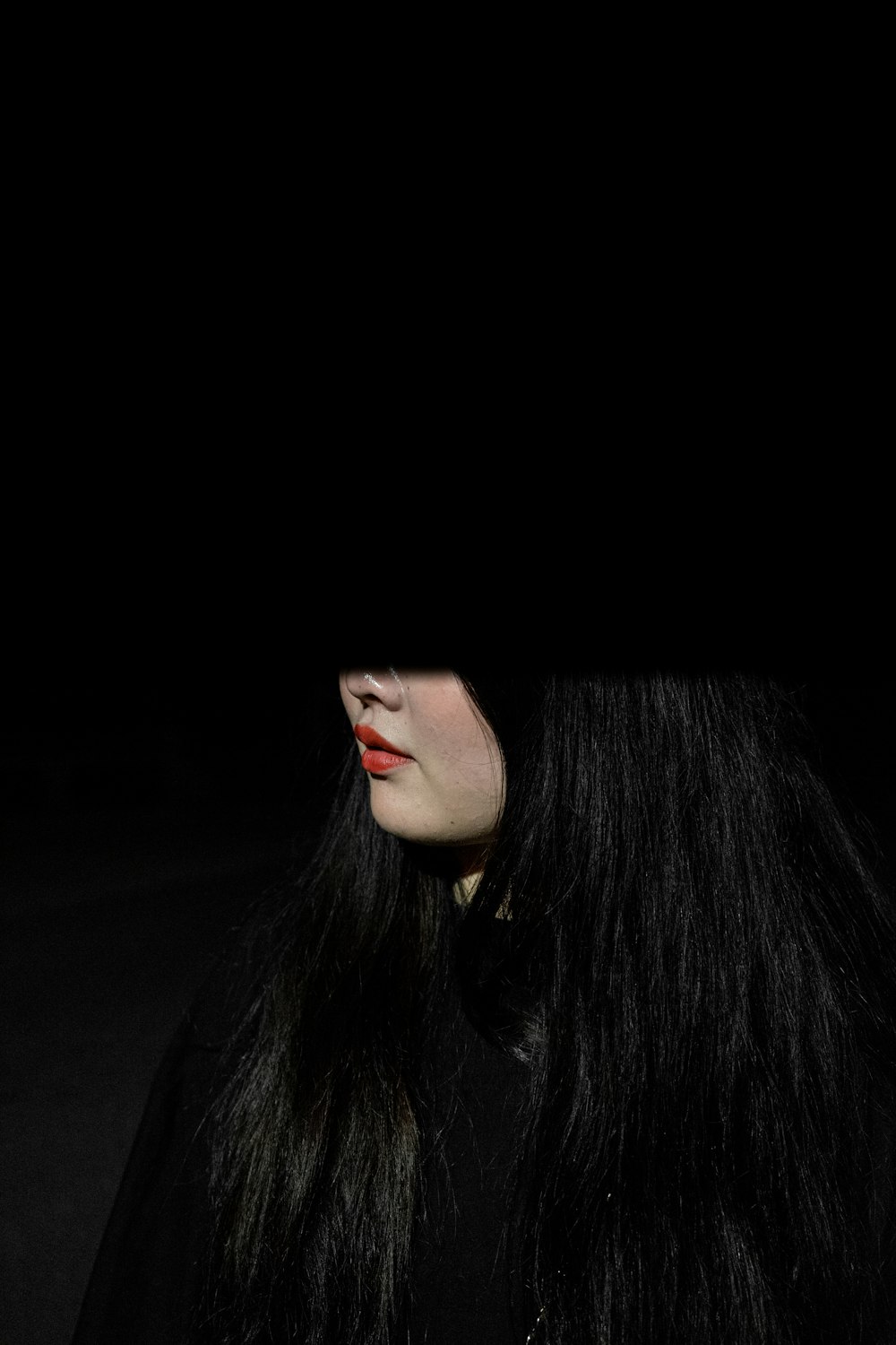 a woman with long black hair and red lipstick
