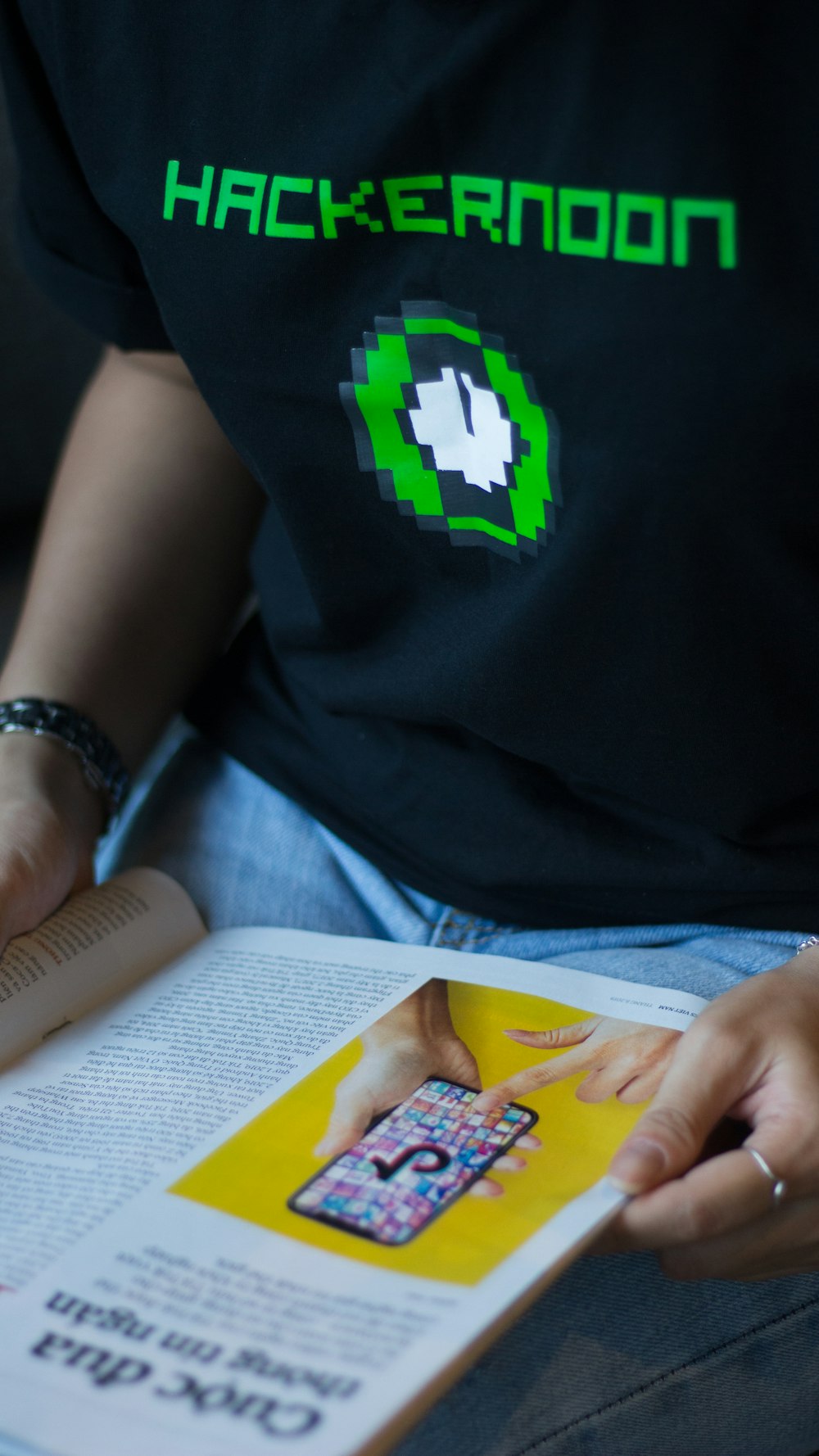 a person sitting down reading a book