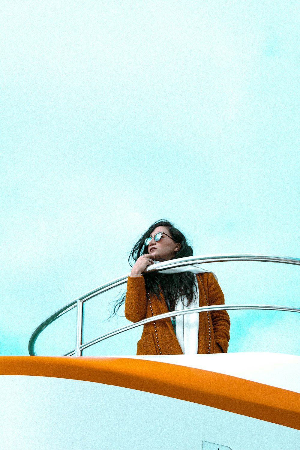 a woman standing on a boat looking up at the sky