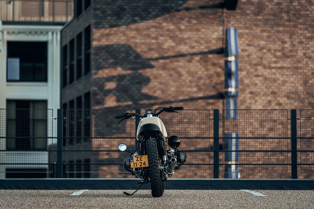 white motorcycle parked near building