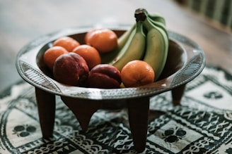 A wooden bowl filled with fresh fruit, highlighting the natural color and texture.