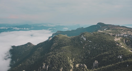 Aerial shot of lush green mountains with mist in Serra da Mantiqueira.