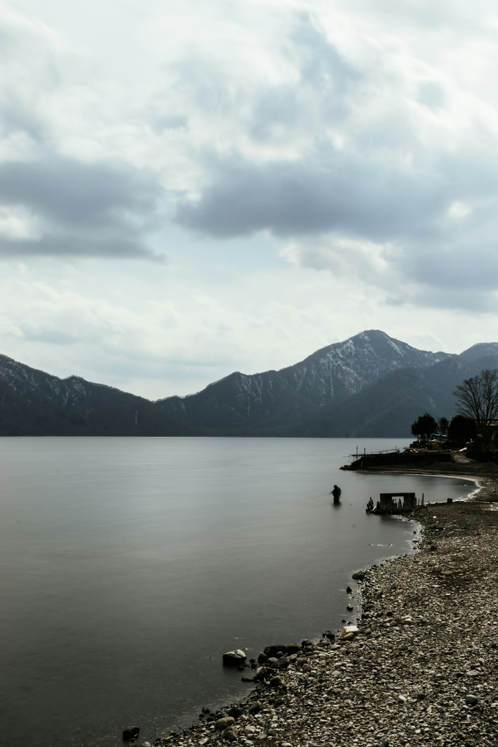 a body of water with mountains in the background