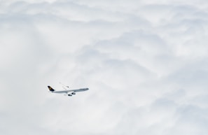 An aerial shot of an airplane soaring above the clouds during a flight booked through Hamsafar.
