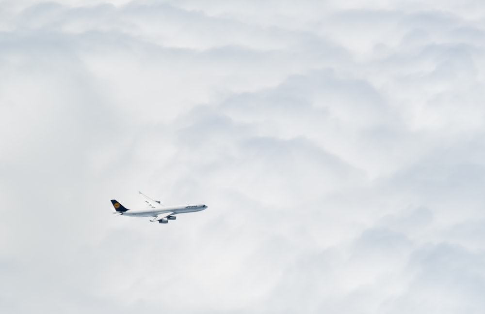 an airplane flying through the clouds in the sky