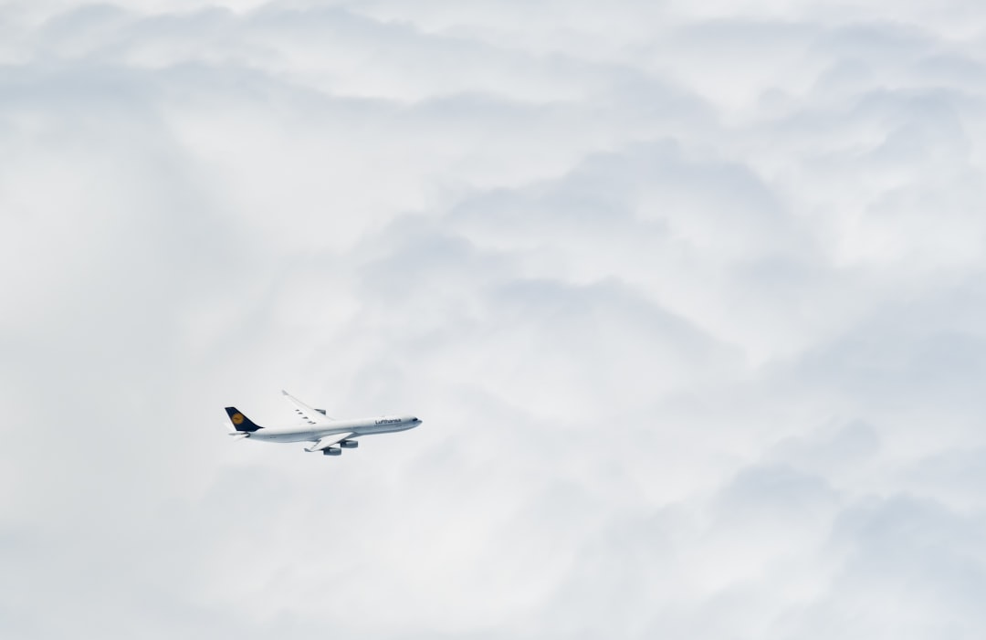 an airplane flying through the clouds in the sky, Lufthansa
