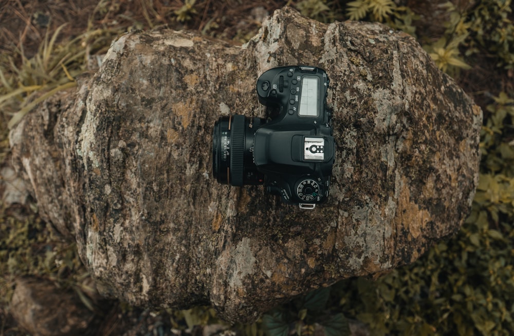 balck DSLR camera on rock