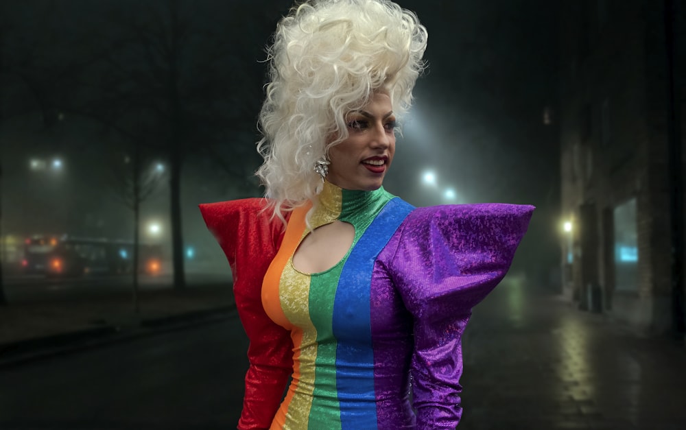 a woman dressed in a rainbow colored outfit